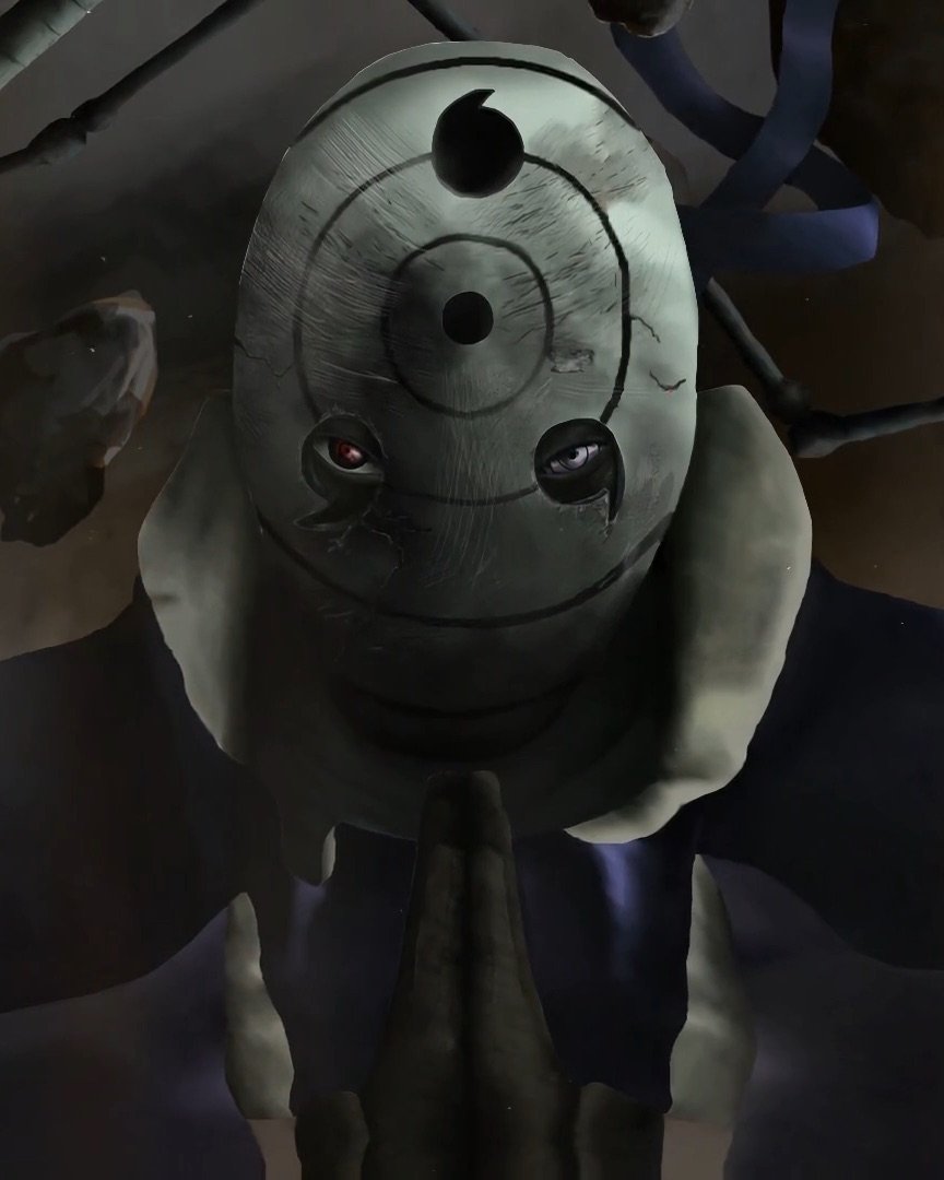 A masked figure in a concentric spiral mask, hands pressed together